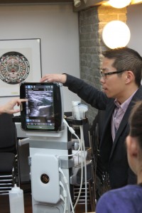 Dr. Dan Kim, faculty mentor for the Ultrasound Club, instructs students on proper ultrasound technique.